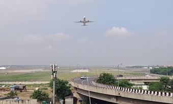 Aircraft flying low above the rooftop terrace at Hotel Aerocity Purple Orchid