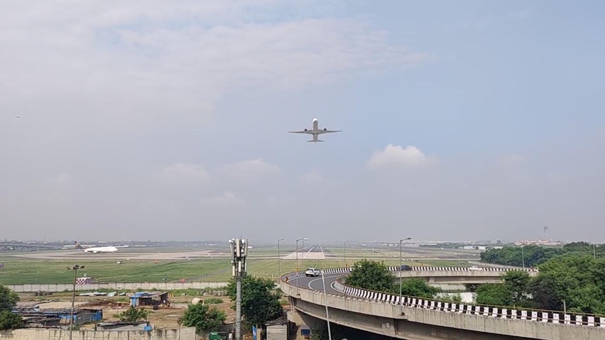 Rooftop terrace at Hotel Aerocity Purple Orchid with aircraft overhead