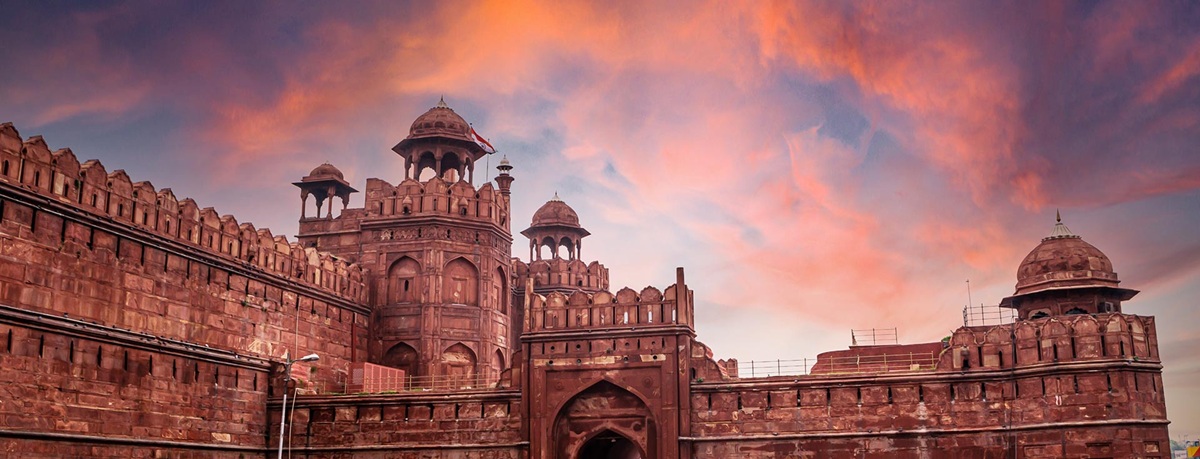 Red Fort, Delhi — red sandstone walls at sunset with visitors